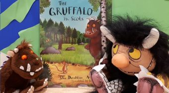 Photo of two plush toys of Gruffalo characters in front of the Gruffalo storybook.