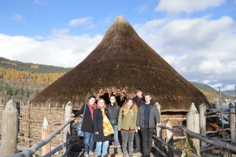 Photo of six young people outside of the crannog.