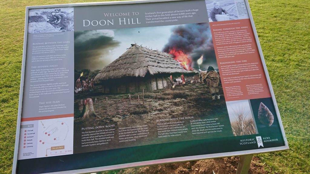 A noticeboard picturing a timber hall on fire
