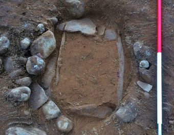 Photo of a small stone circle in which a beaker burial pot was found.