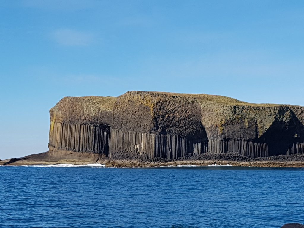 An island made of basalt columns in the sea