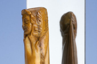 A carved handle with a person's face on it