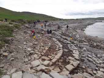A coastal site with people around it