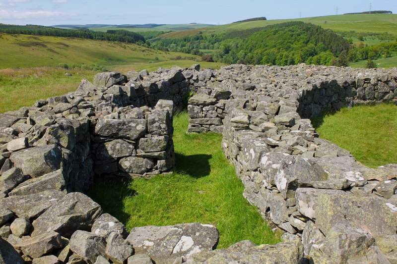Photo of a low stone wall, showing the foundations on an Iron Age broch