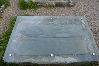 Photo of a carved stone tomb lid showing a medieval knight
