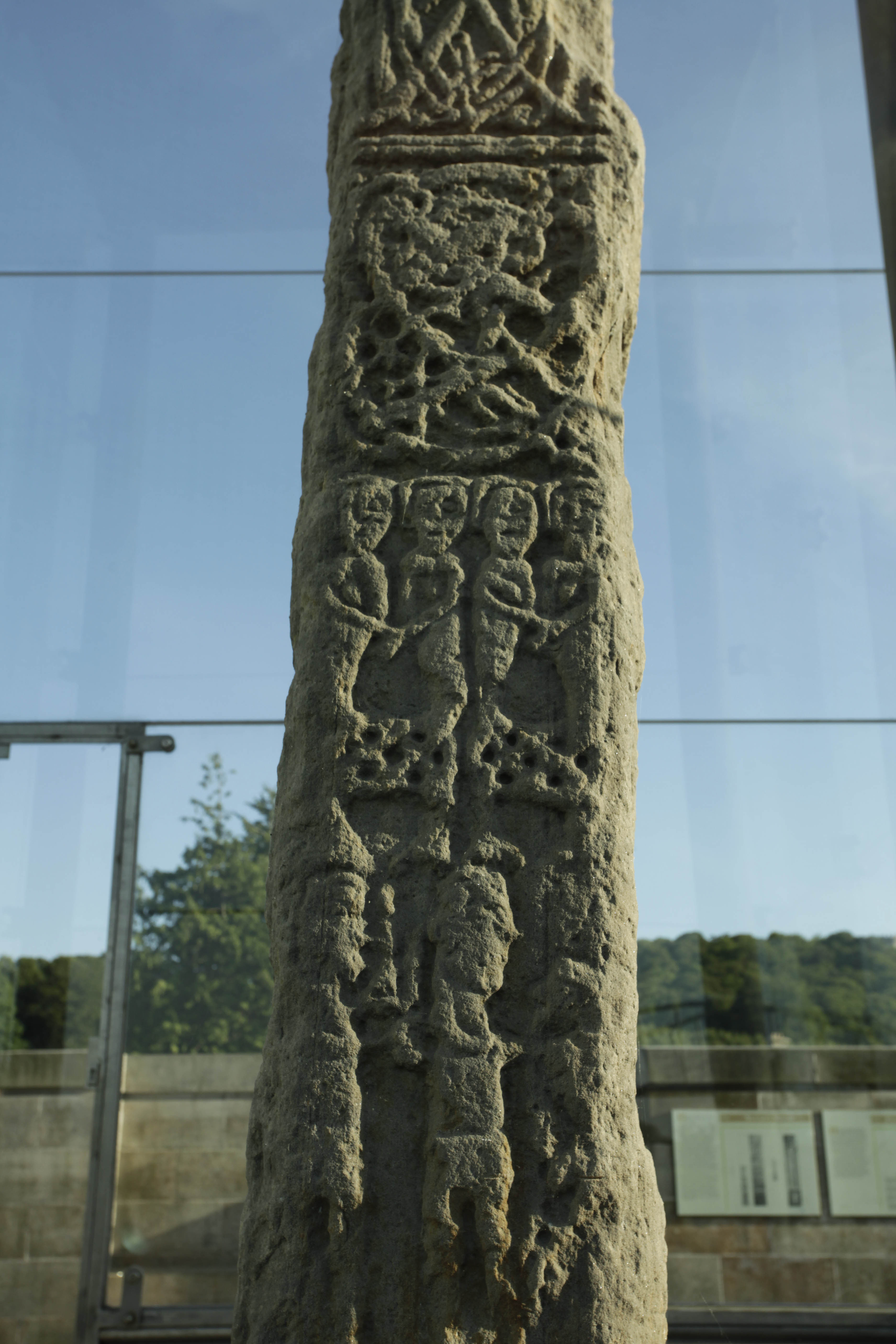 Photo of a carved standing stone depicting a battle scene.