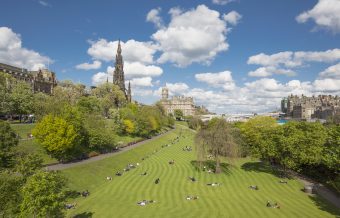 People enjoying the sun in Princes Street Gardens.