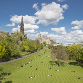 People enjoying the sun in Princes Street Gardens.
