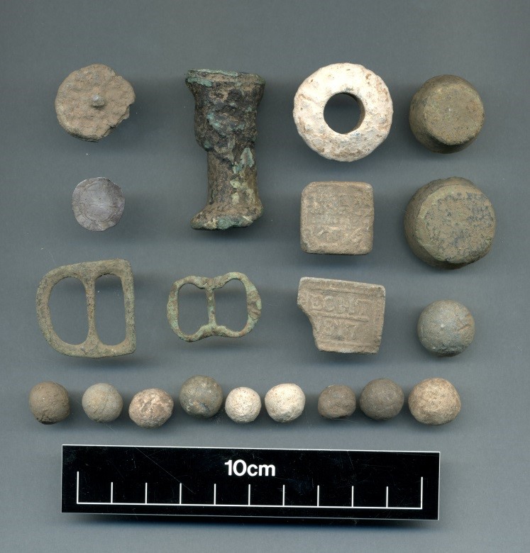 An assortment of small, lead, clay an metal finds from the ground.