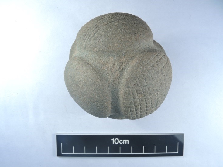 Photo of a carved stone ball with raised nodules.