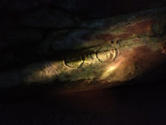 A carving of two circles on a cave wall