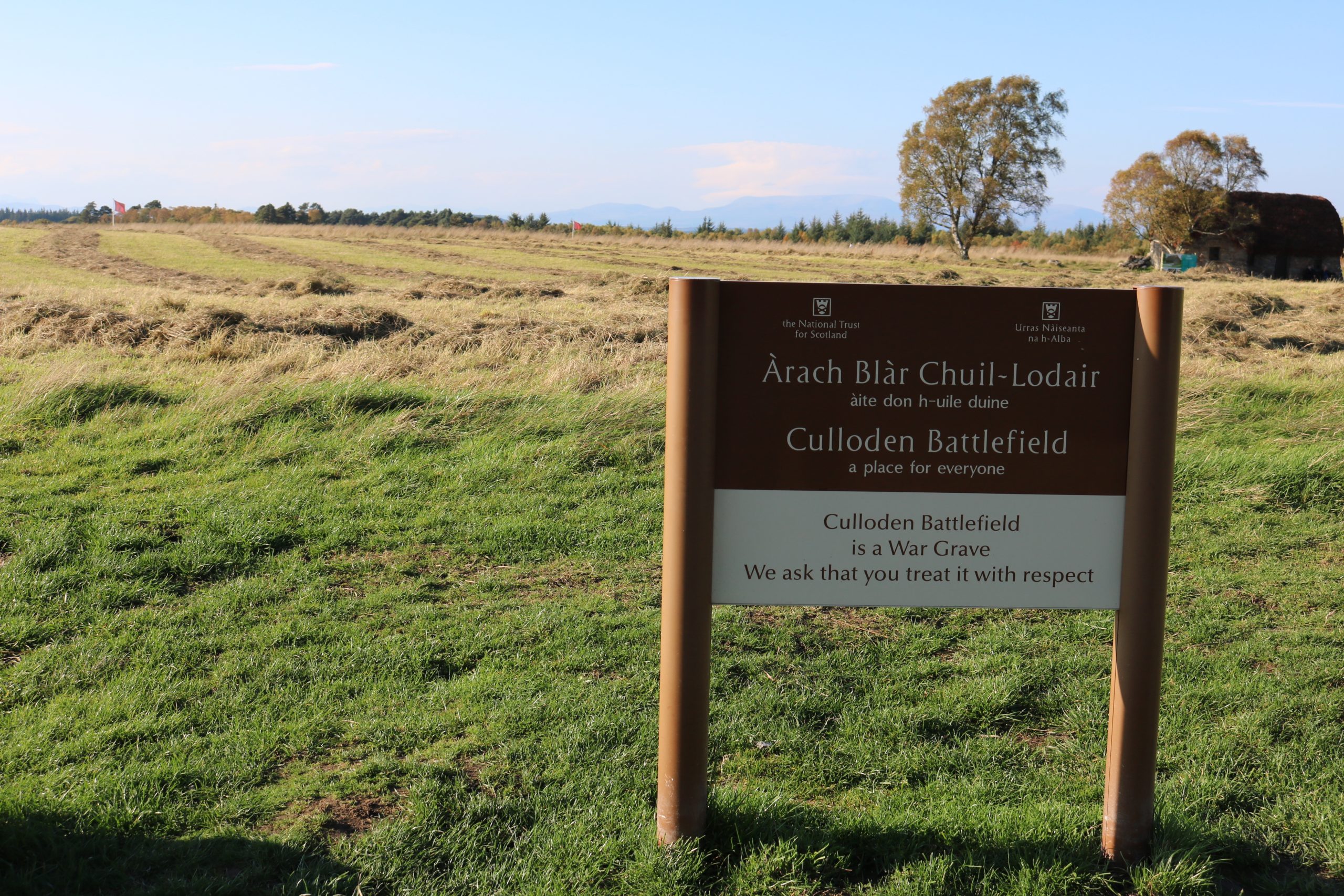 A National Trust for Scotland sign on a battlefield which says ‘Culloden Battlefield is a War Grave. We ask that you treat it with respect’.