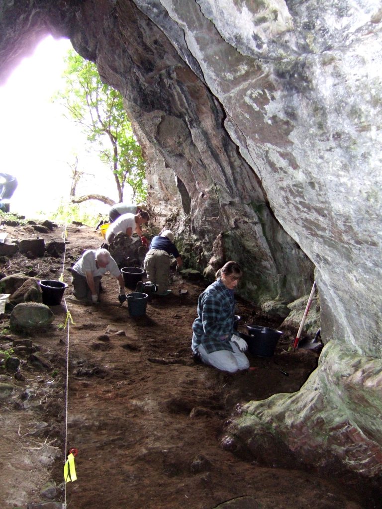 Archaeologists working in a cave