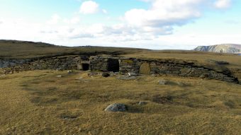 A stone structure covered in grass