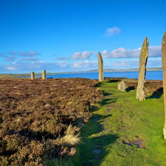 Photo of a huge ring of large standing stones by the sea.
