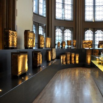 Photo of an exhibition of carved stone in a museum.