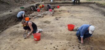 Several people in a large trench