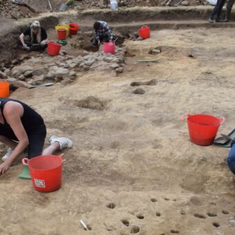 Several people in a large trench