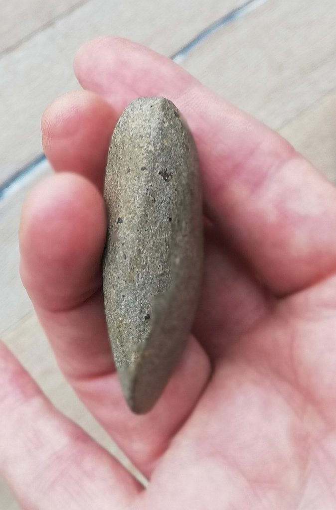 Someone holding a polished rock