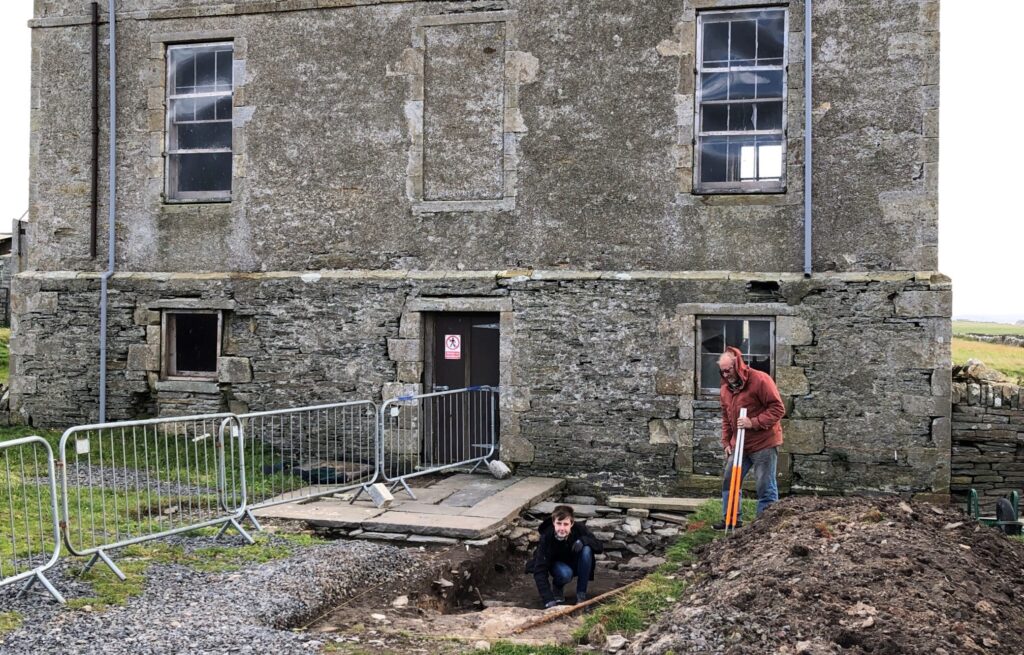 Andrew Appleby, President of the John Rae Society, and Brody Laroux, a young volunteer, at the site of the Hall of Clestrain excavation