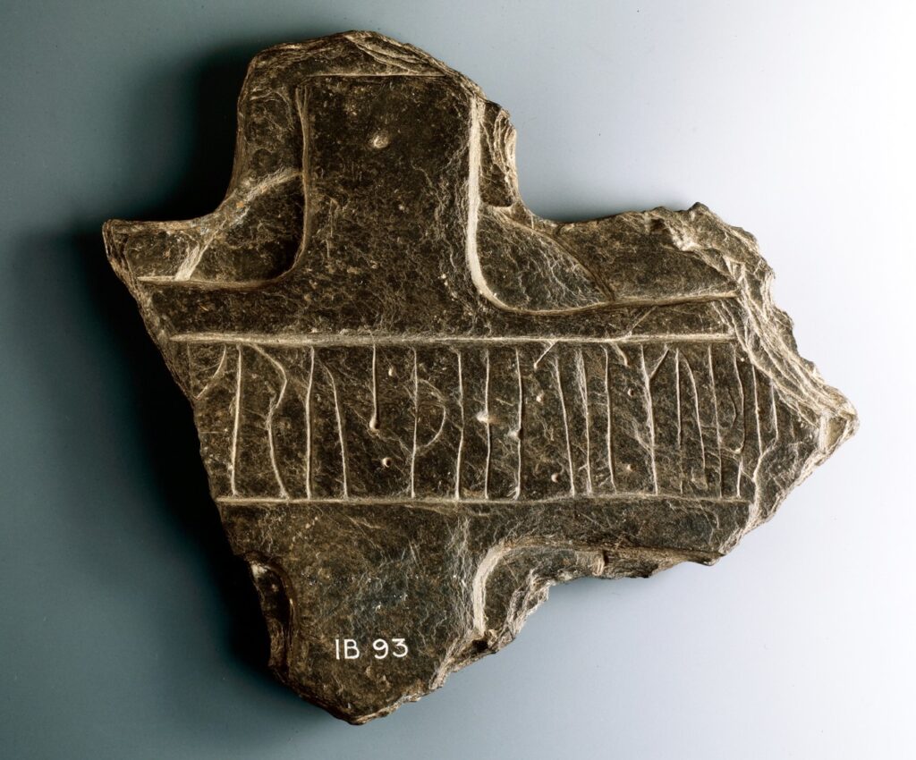 Portion of a cross head of schistose slate inscribed with runes