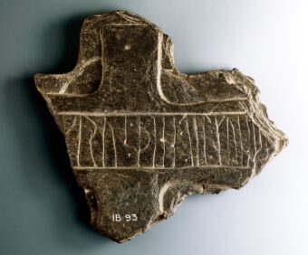 Portion of a cross head of schistose slate inscribed with runes