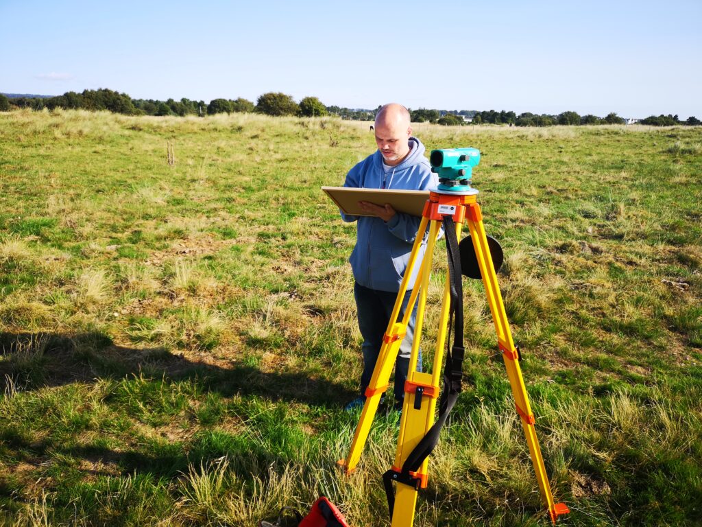 Photo of a person recording a site on paper