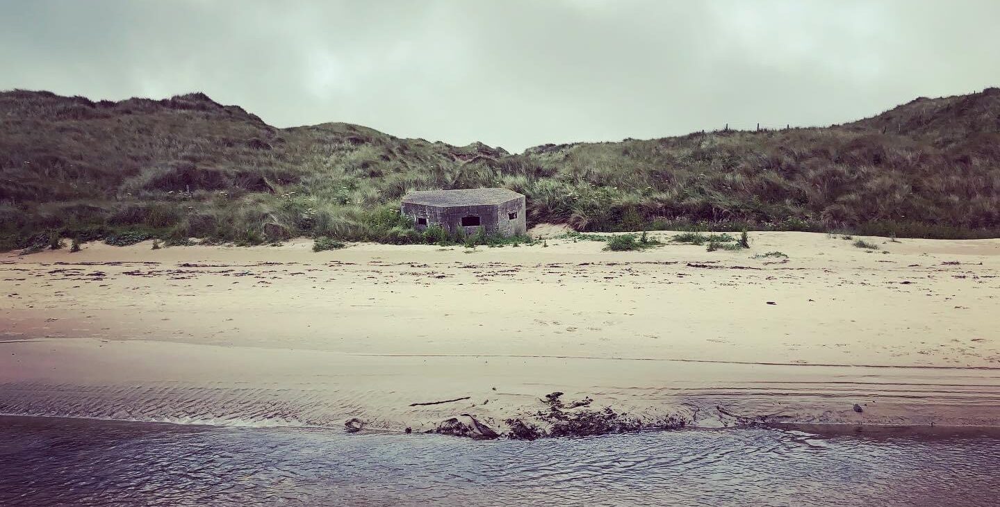 A small concrete structure on a beach 