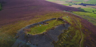 A hill with a dig happening on it