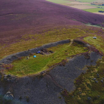 A hill with a dig happening on it