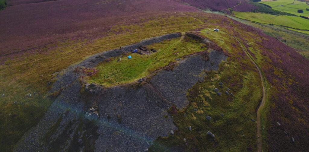 A hill with a dig happening on it
