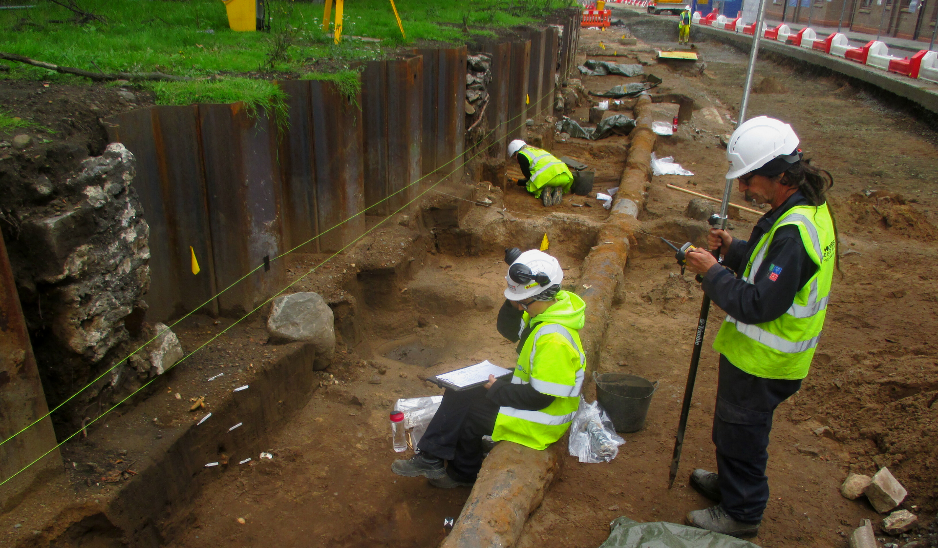 People standing in a dig site
