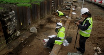 People standing in a dig site