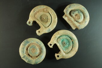 Photo of four bronze horse harness buckles