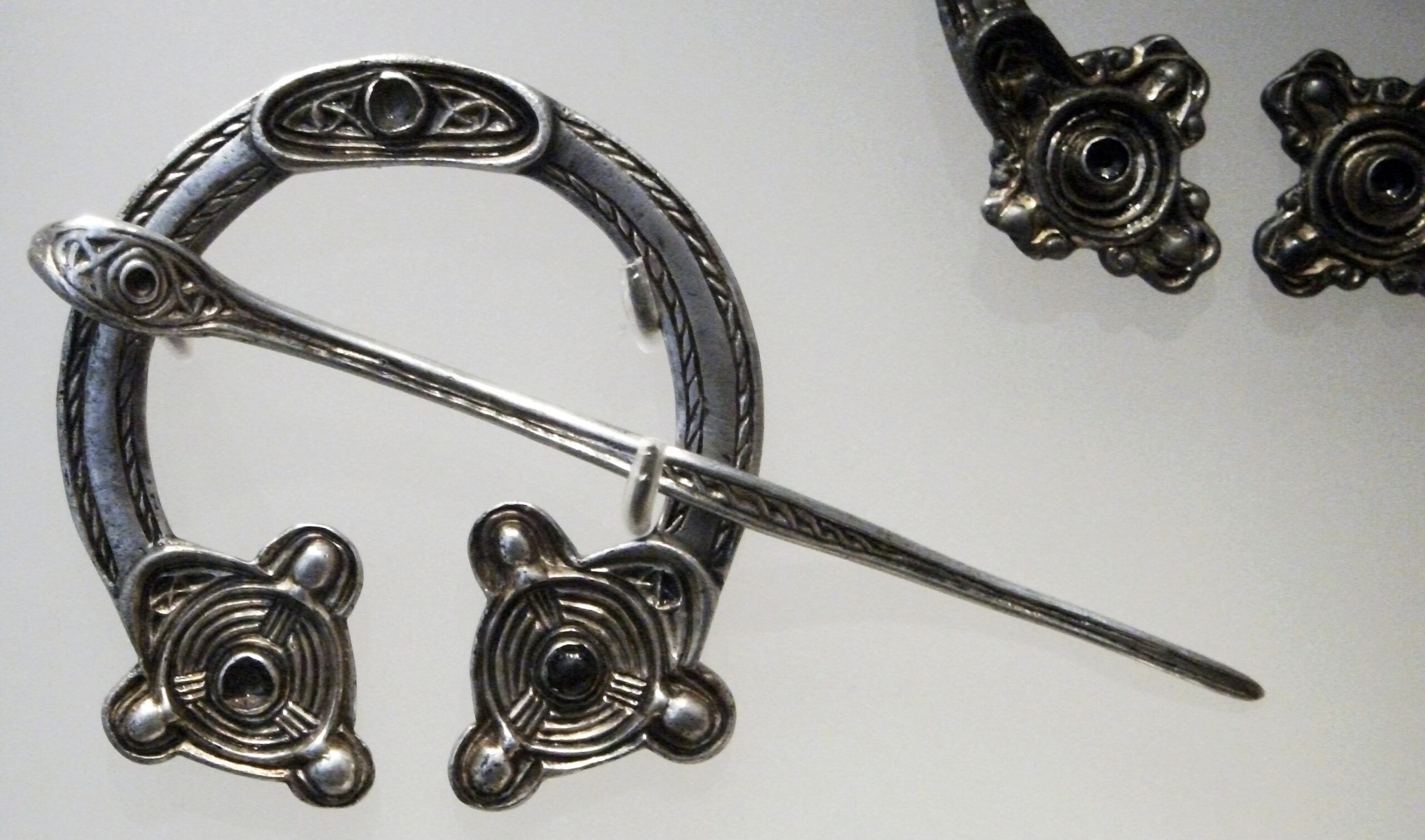 Photo of a silver horseshoe-shaped brooch and pin