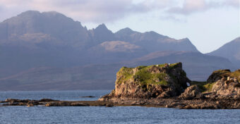 Photo of a ruined stone castle by the sea