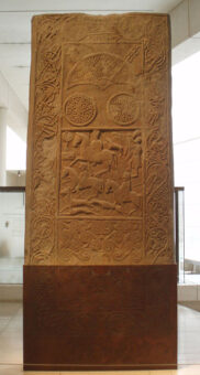 Photo of a brown carved stone showing a mounted warrior