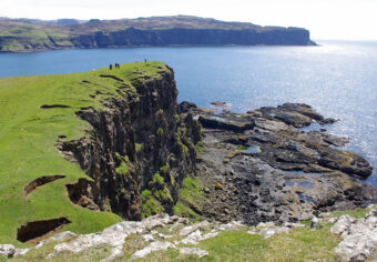 Photo of a green topped cliff by the sea