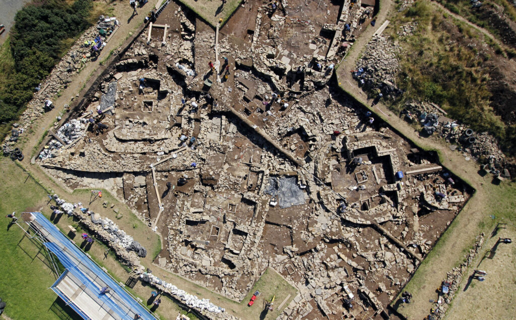 Aerial view of several stone structures uncovered as part of a large excavation