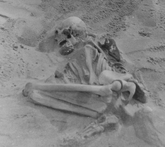 Black and white photo of a crouched human burial