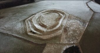 Aerial view of circular ditches dusted with snow