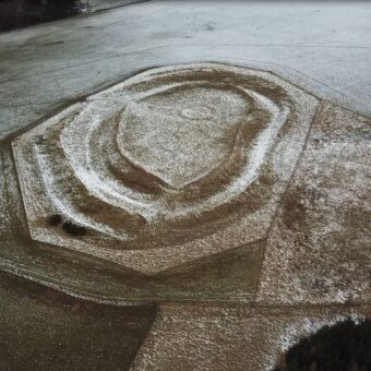 Aerial view of circular ditches dusted with snow