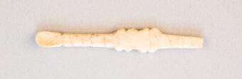 Photo of a tiny bone ear scoop