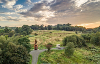 Photo of a landscape with a large metal Roman soldier head sculpture