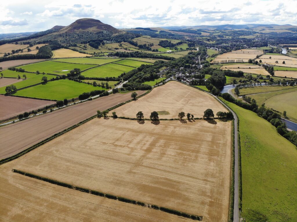 Aerial photo of fields with hills in the background