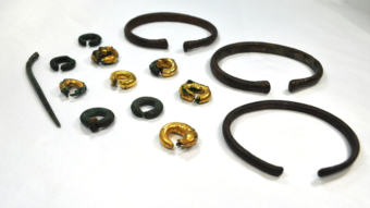 Several gold and brown artefacts shaped like rings and bracelets