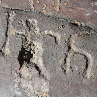 Photo of a carving of a warrior on a cave wall