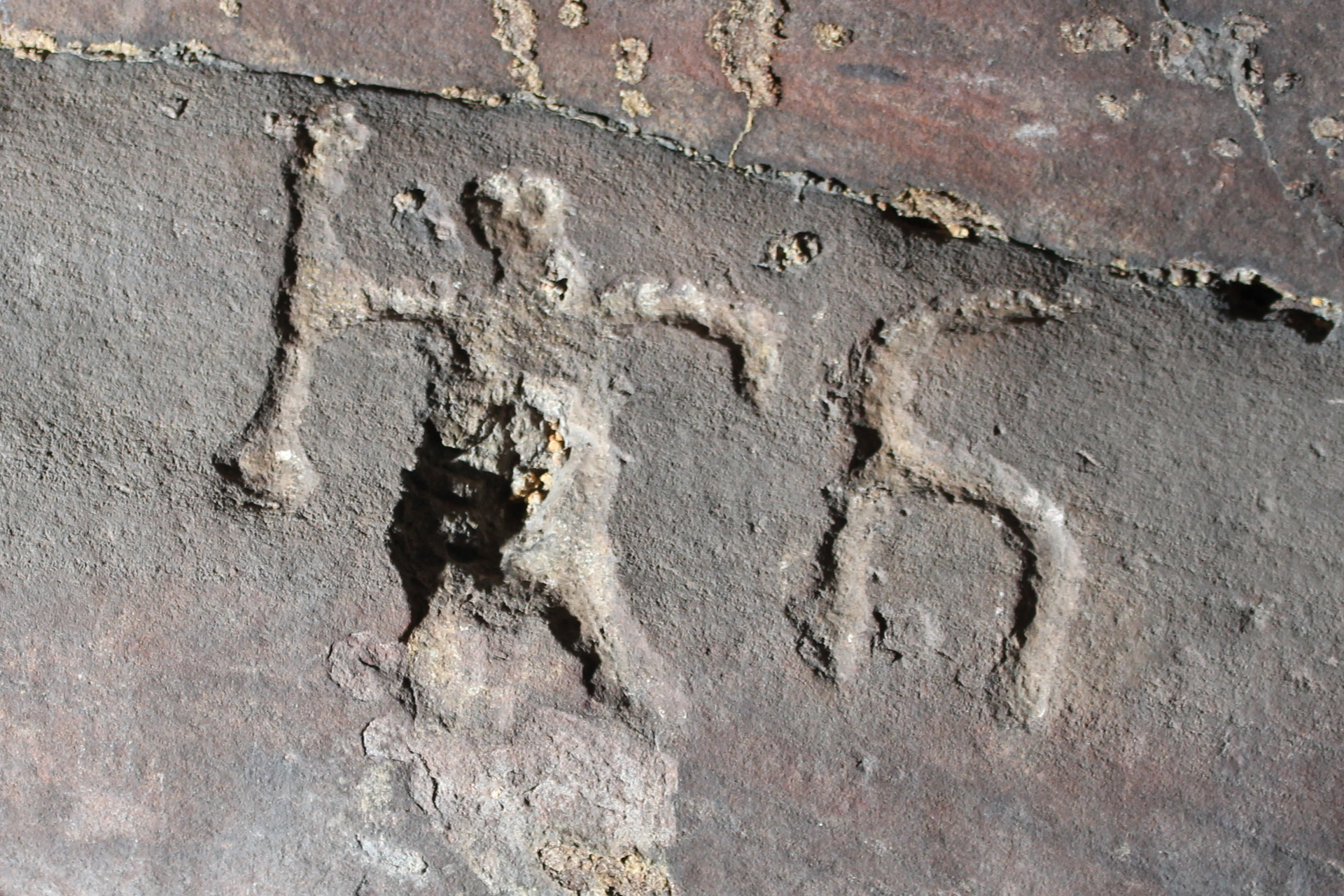 Photo of a carving of a warrior on a cave wall