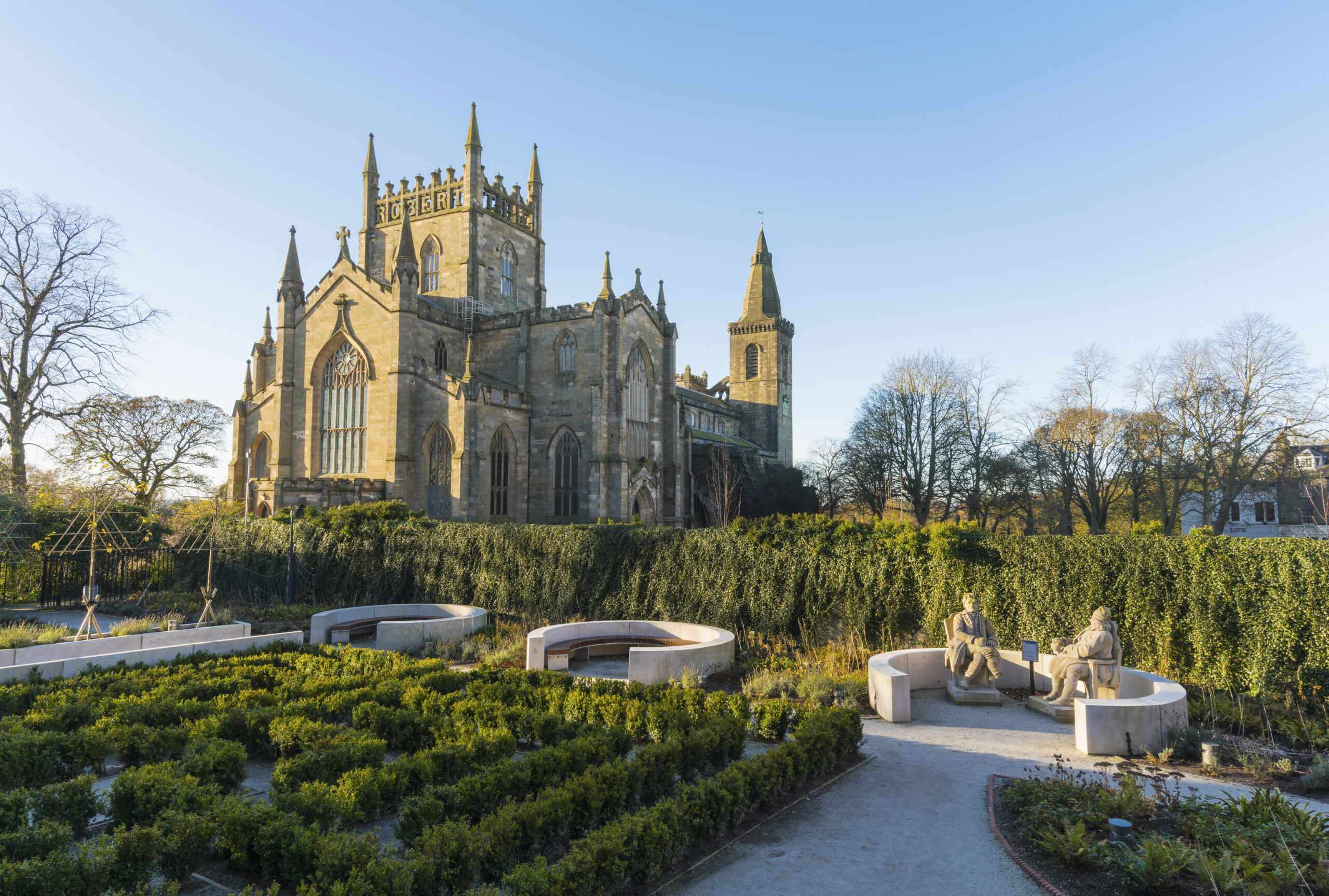 Photo of an abbey with a garden in the foreground