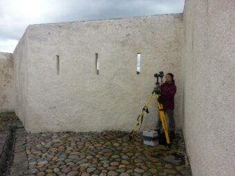 Person taking a photograph in an old building